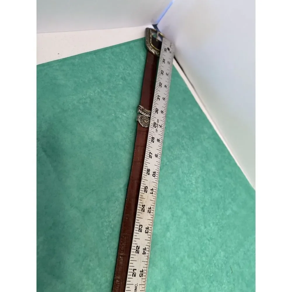Ladies leather reversible belt black and brown with embellishments. Size med/30.